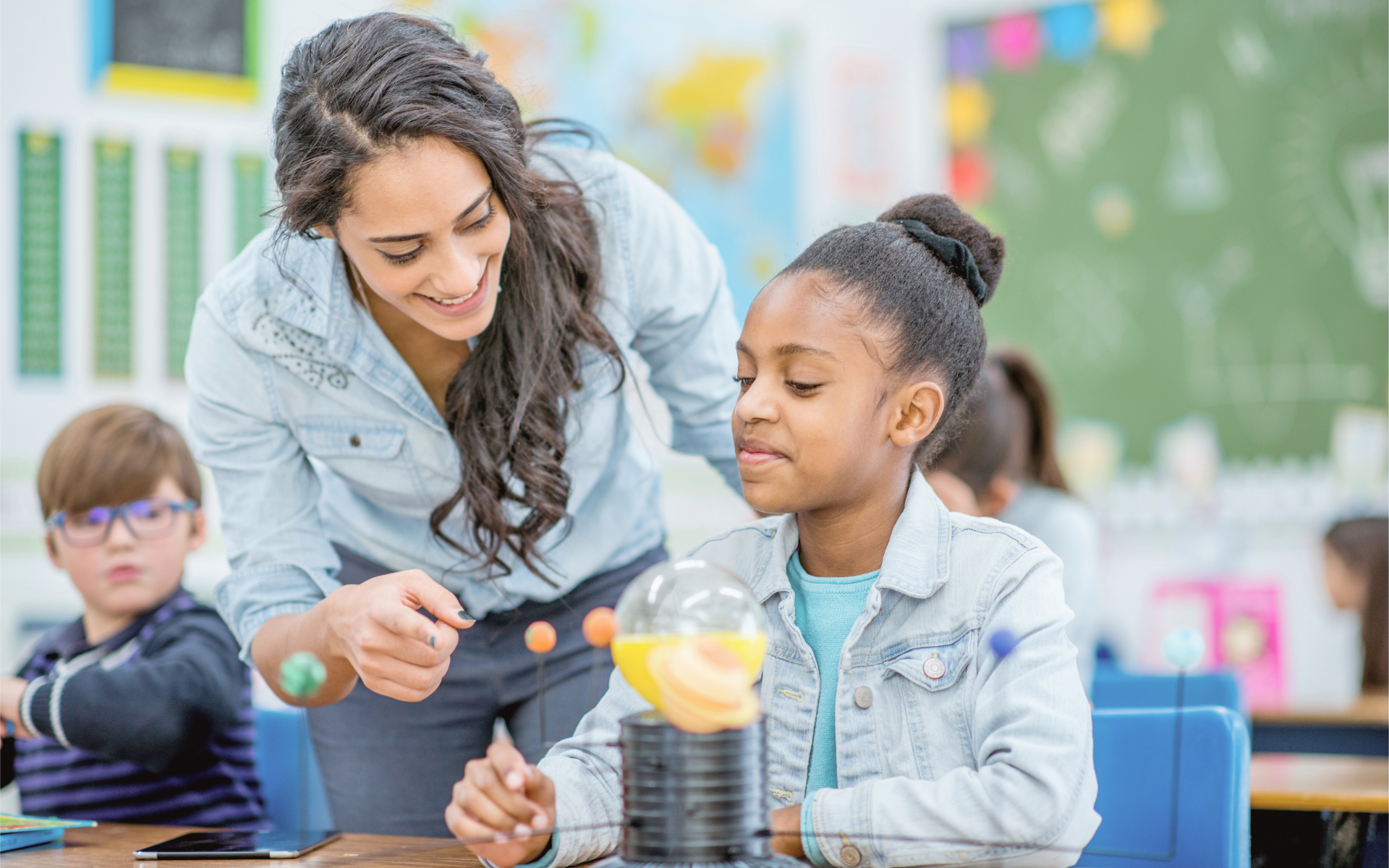 A teacher helps a student in the classroom