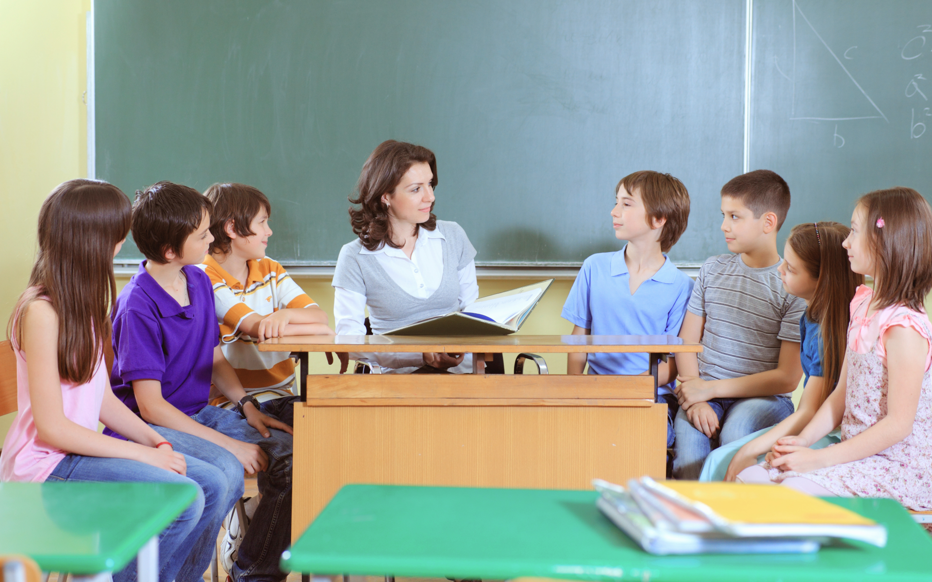 A teacher reads to students in the classroom